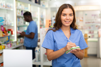 Pharmacist standing with notebook
